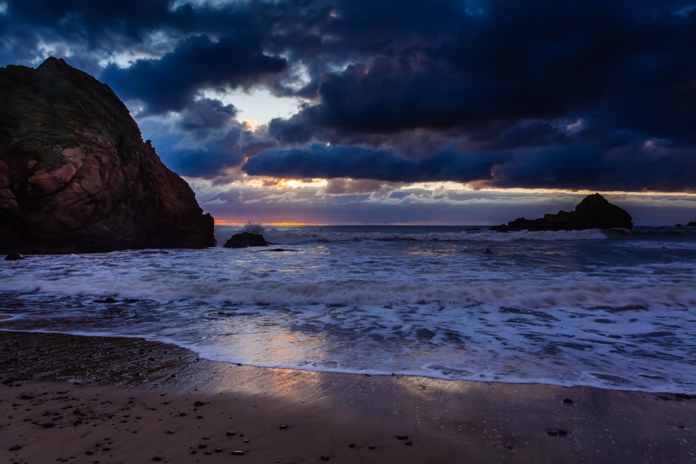 sea under cloudy sky during golden hour