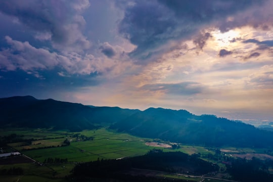 green mountain and field during daytime in Sopó Colombia