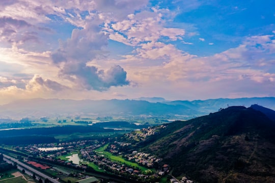 aerial photography of city buildings under green mountain during daytime in Sopó Colombia