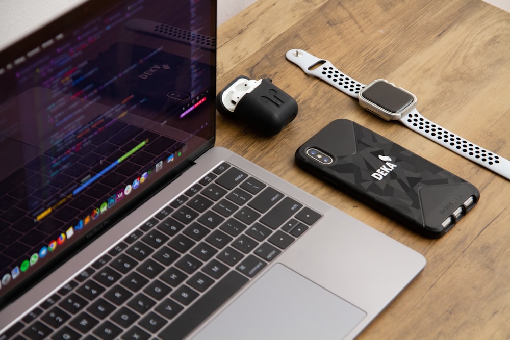 Apple watch, iPhone, AirPods and MacBook on table