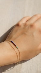 A single bracelet draped over a hand, sunlight catching the crystals’ facets.