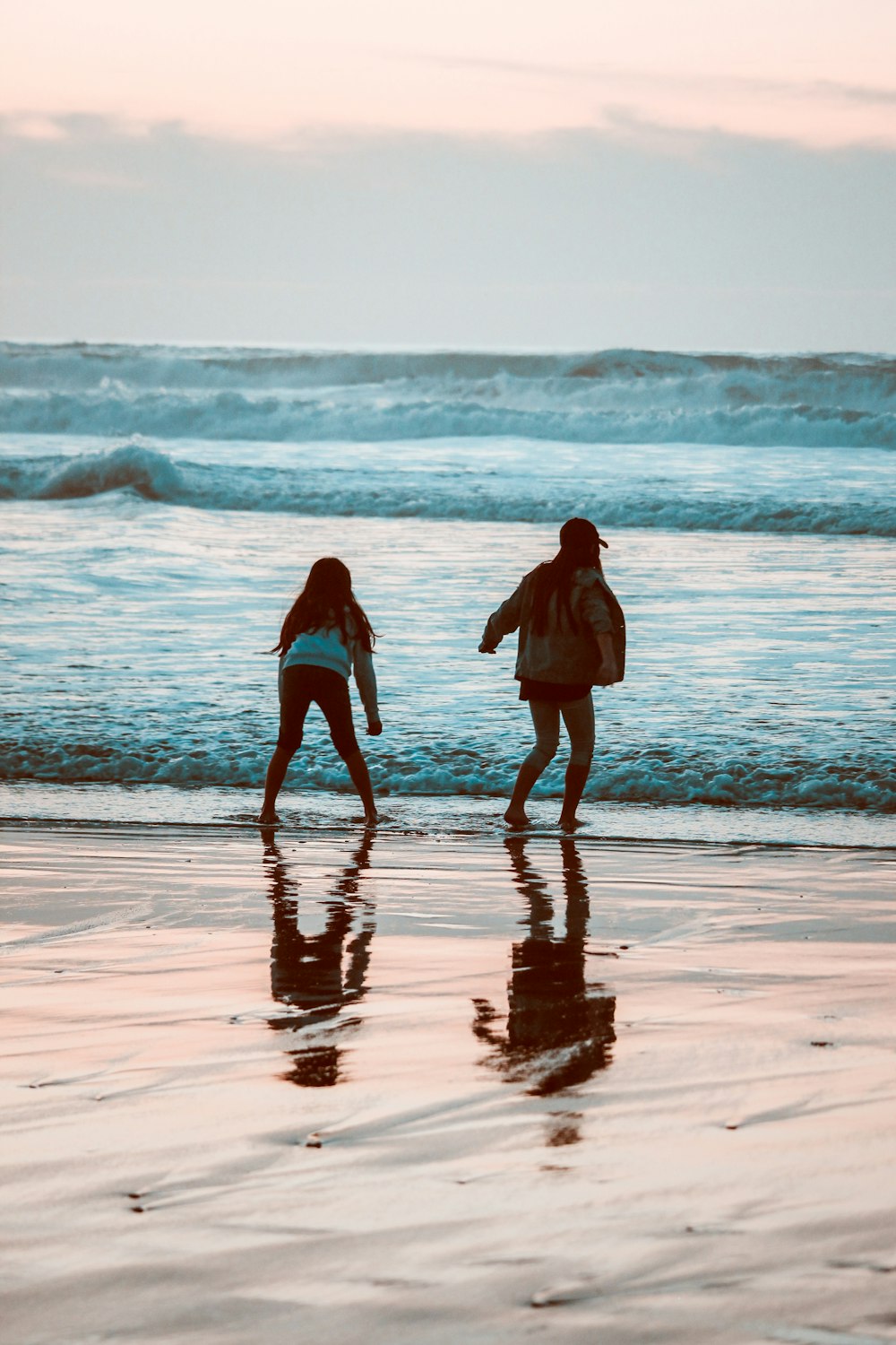 two women playing on shore