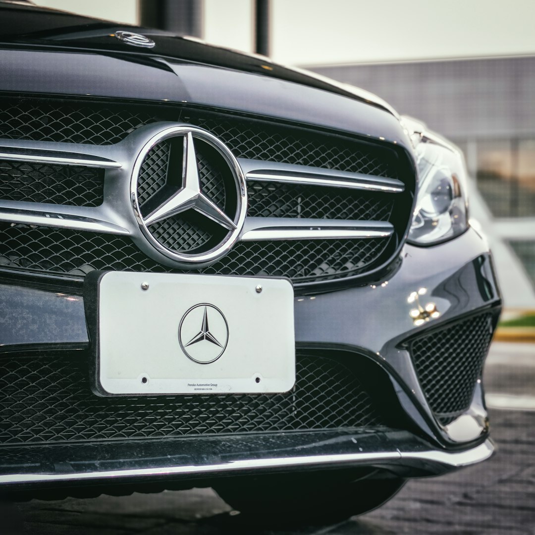 A black Mercedes Benz sits in front of a dealership in Fairfax VA. 