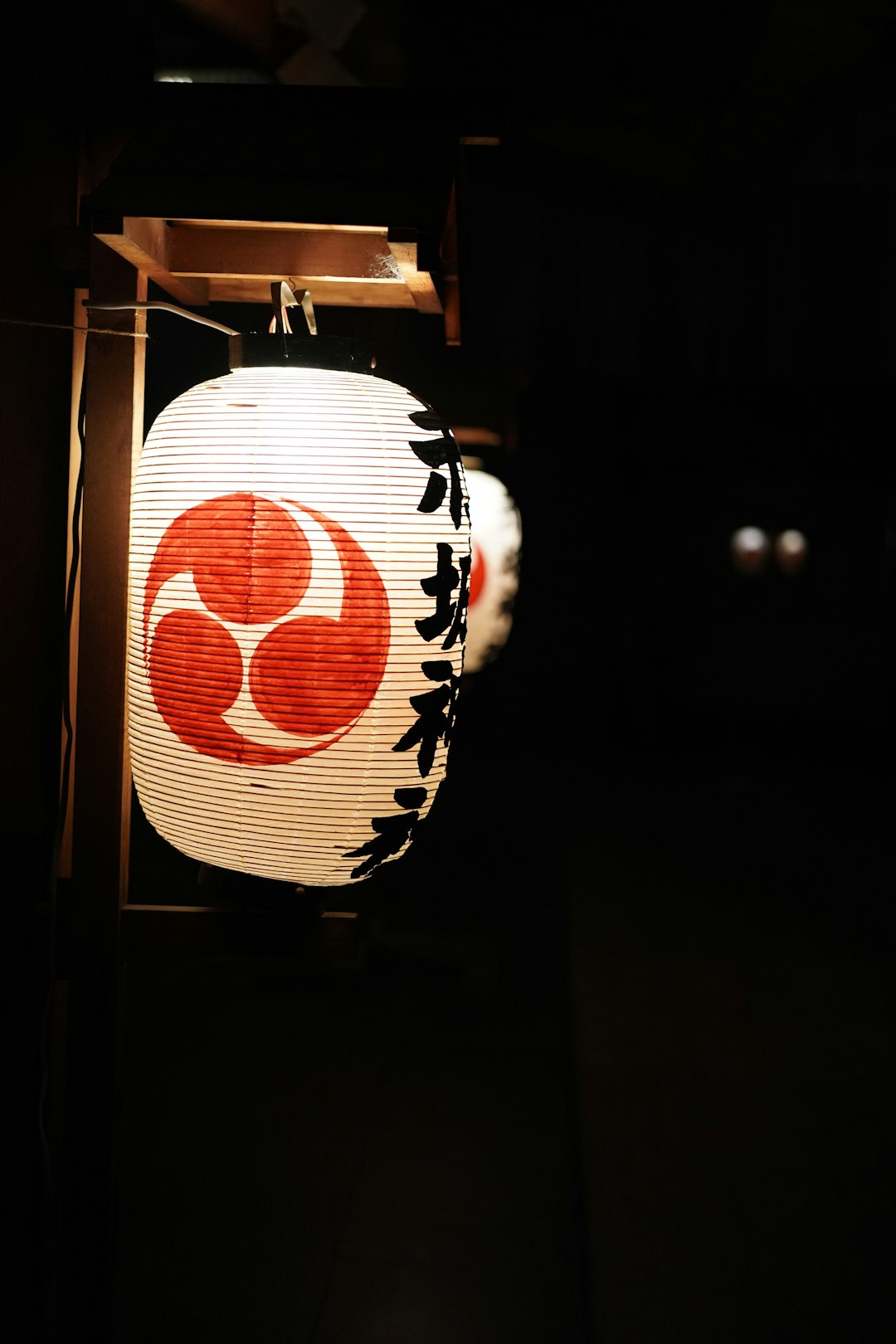 turned-on white and red Chinese lantern at night