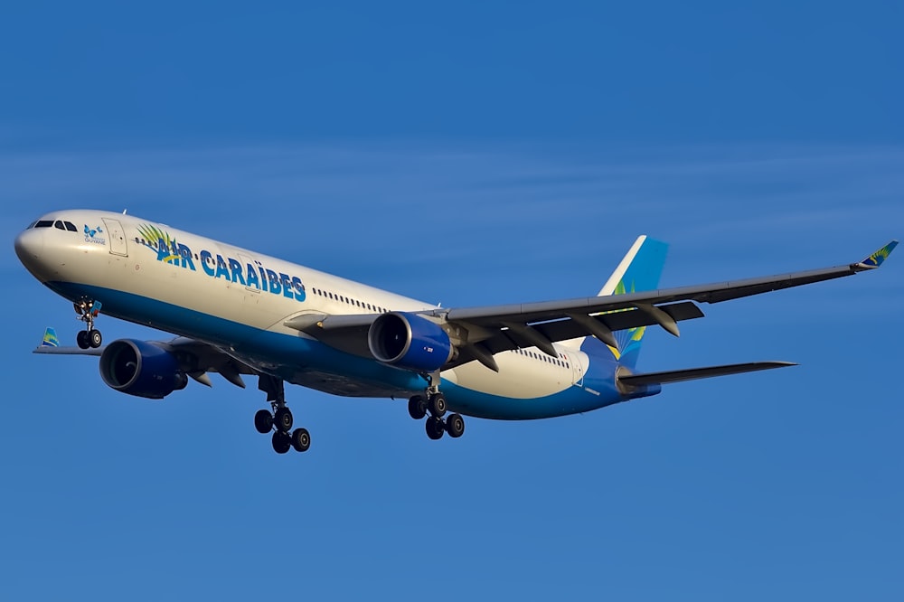 white and blue Air Caraibes passenger plane