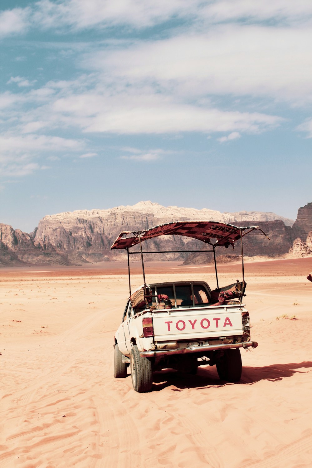 white Toyota pickup truck under white clouds