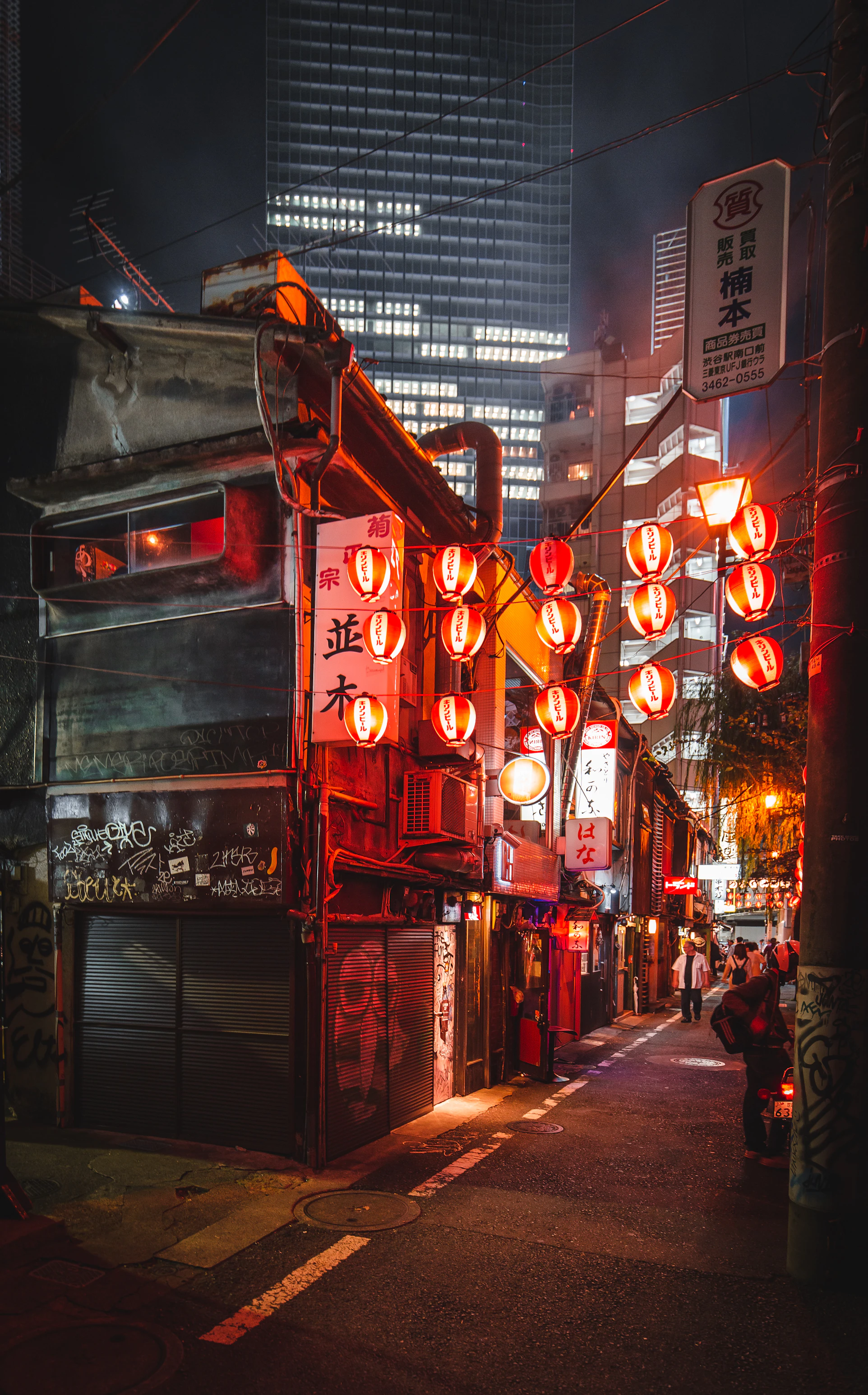 Lantern glowing on a quiet street at night