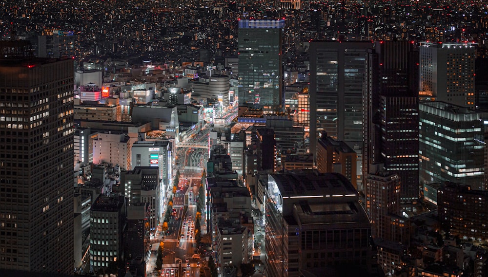 a view of a city at night from the top of a skyscraper