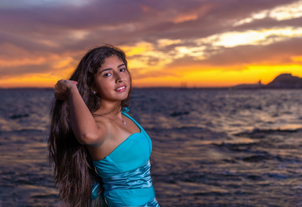 selective focus photography of smiling woman standing near sea