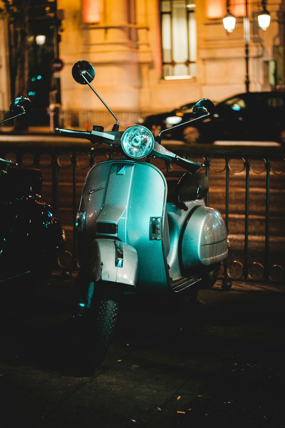 grey motor scooter at night