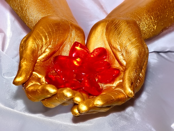 Hands gracefully arranging a collection of vibrant precious gems.