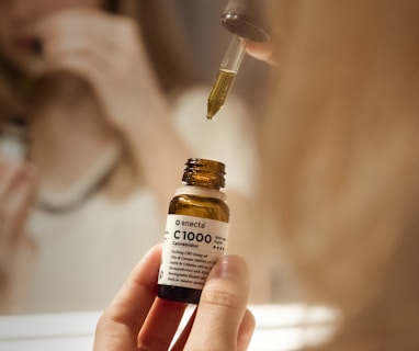 selective focus photography of person holding C1000 bottle
