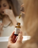 selective focus photography of person holding C1000 bottle