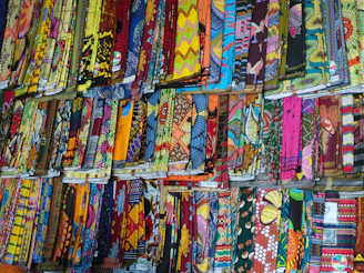 Rows of vibrant sarees hanging gracefully in a boutique, highlighting textures and colors.