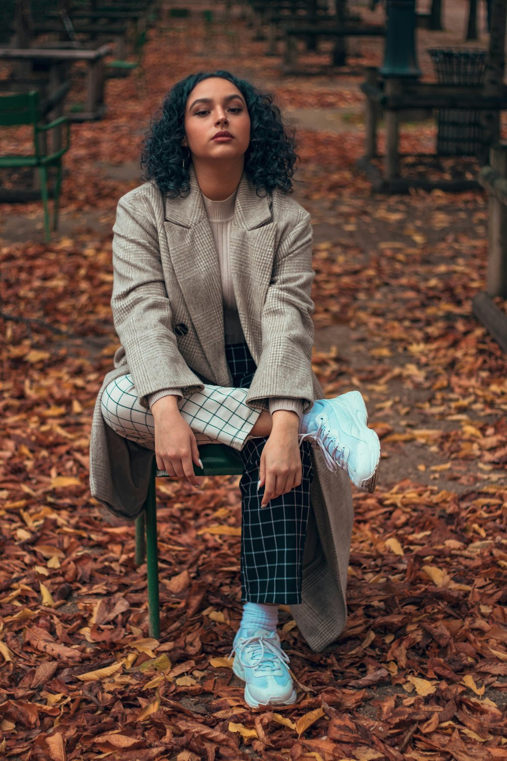 woman in gray coat sitting on chair