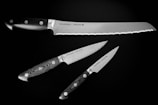 three black kitchen knifes