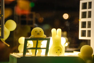 a couple of little yellow bunnies sitting on top of a table