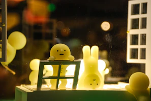 a couple of little yellow bunnies sitting on top of a table