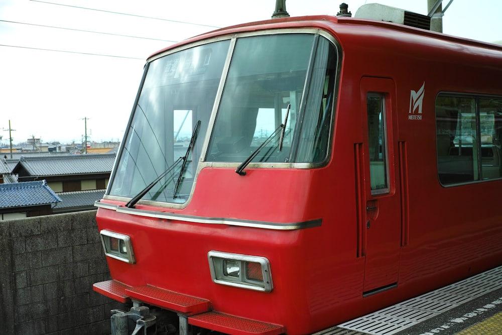 red train beside wall