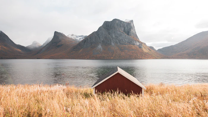 A wooden shack beside a body of water