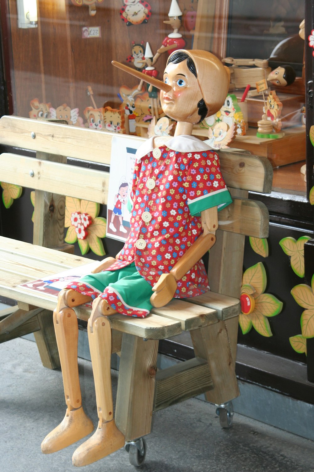 Pinocchio statue on wooden bench