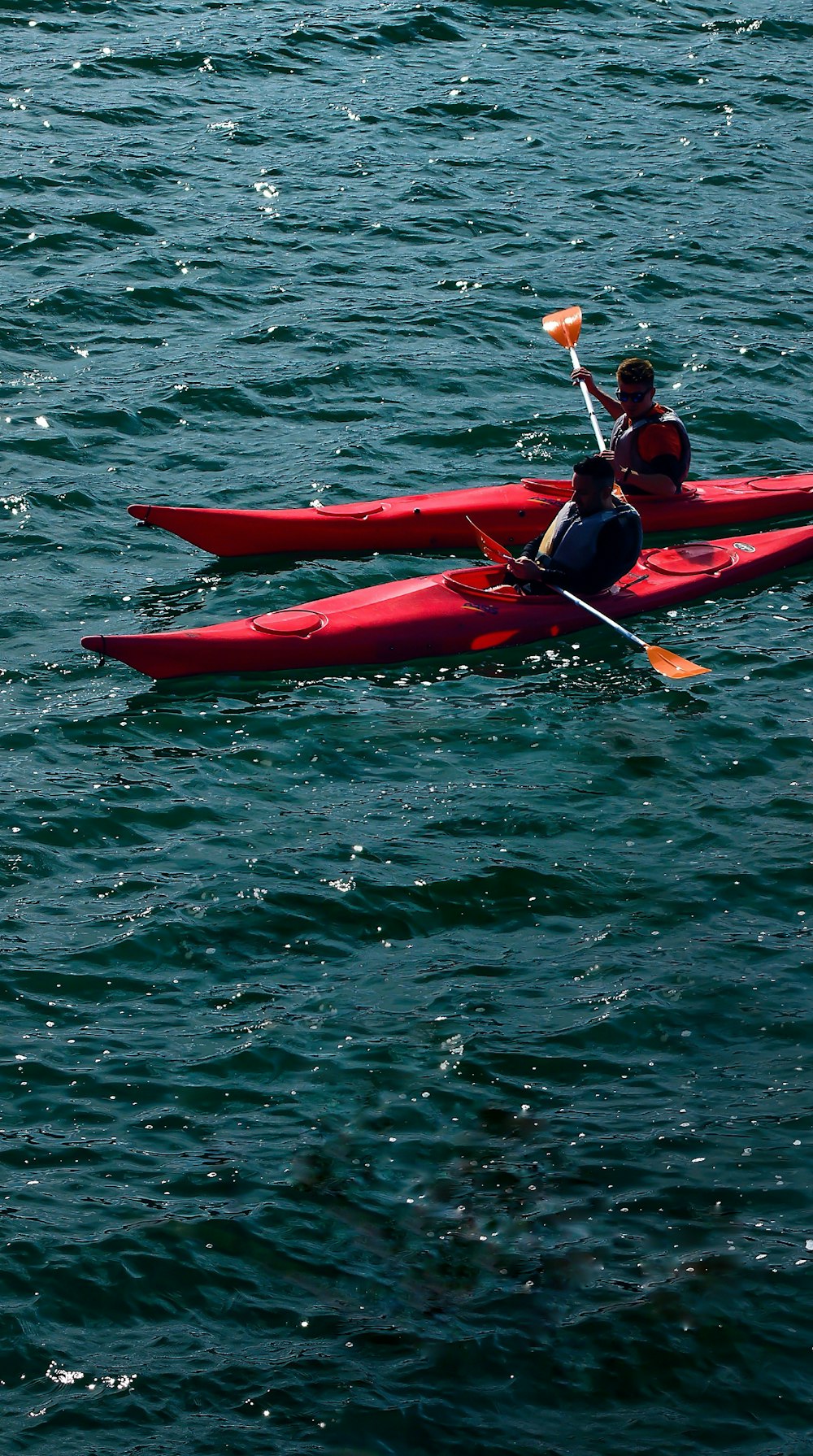 two person kayaking on body of water