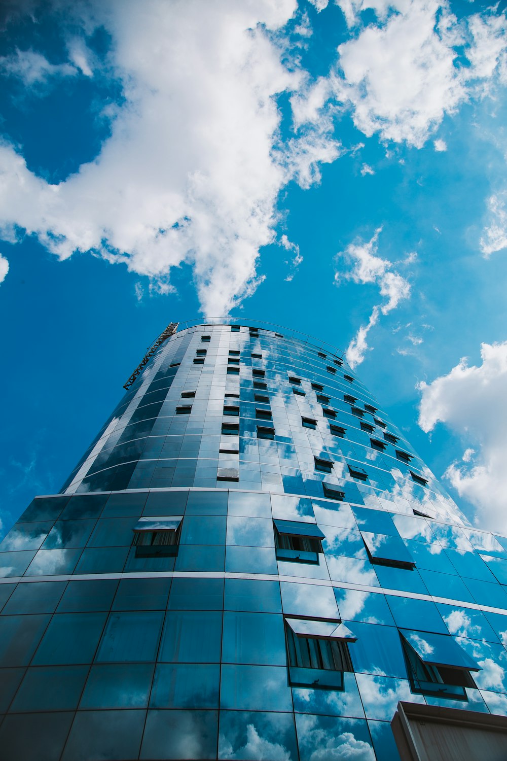 low-angle photography of blue high-rise glass building during daytime