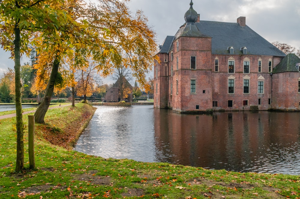 body of water near trees and house during daytime