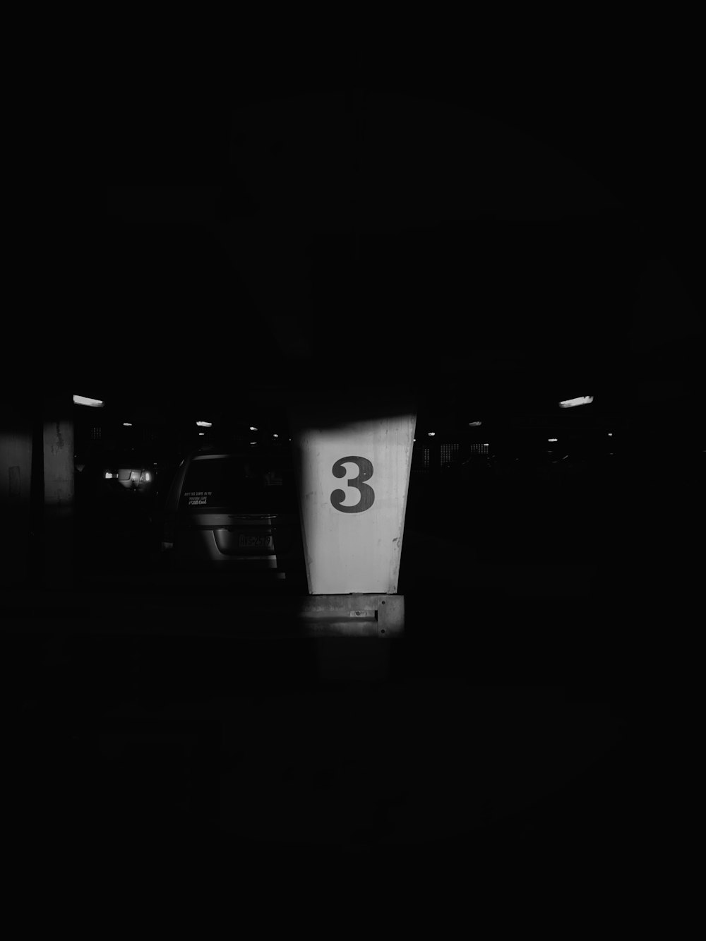 a black and white photo of a parking garage