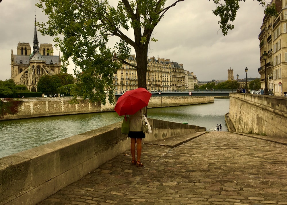 woman holding red umbrella