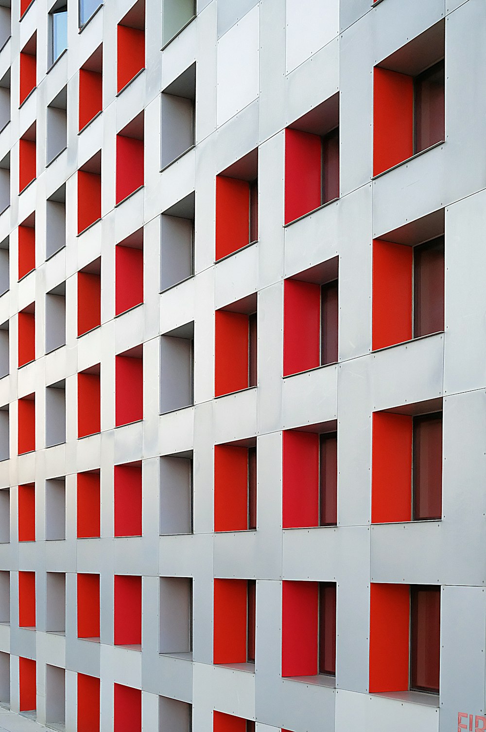 gray and red concrete multi-storey building