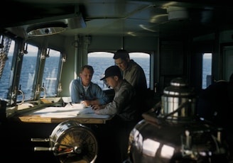 three men inside ships cabin
