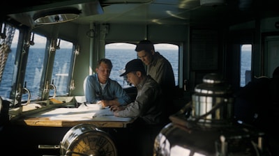 three men inside ships cabin