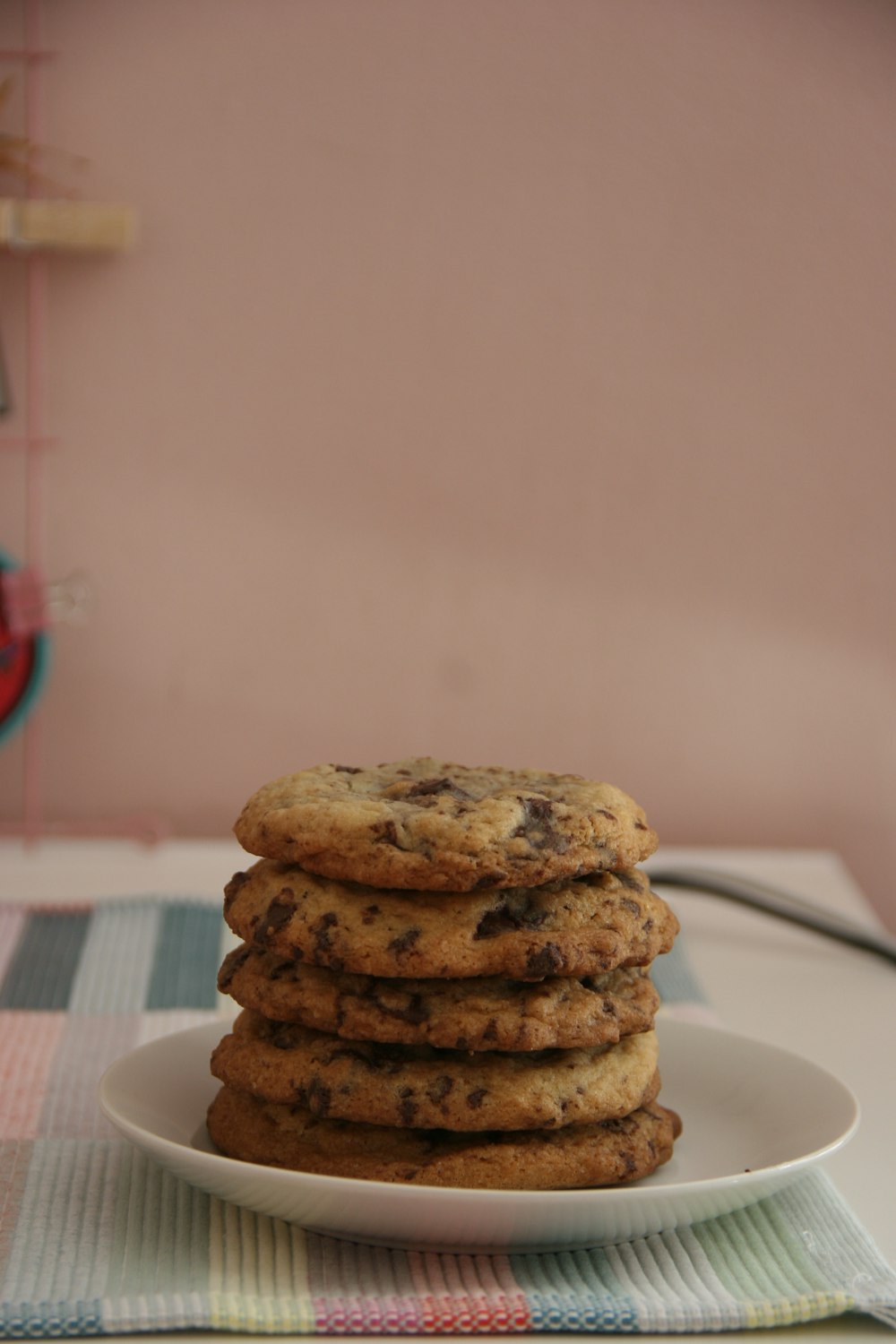 five cookies on white ceramic saucer