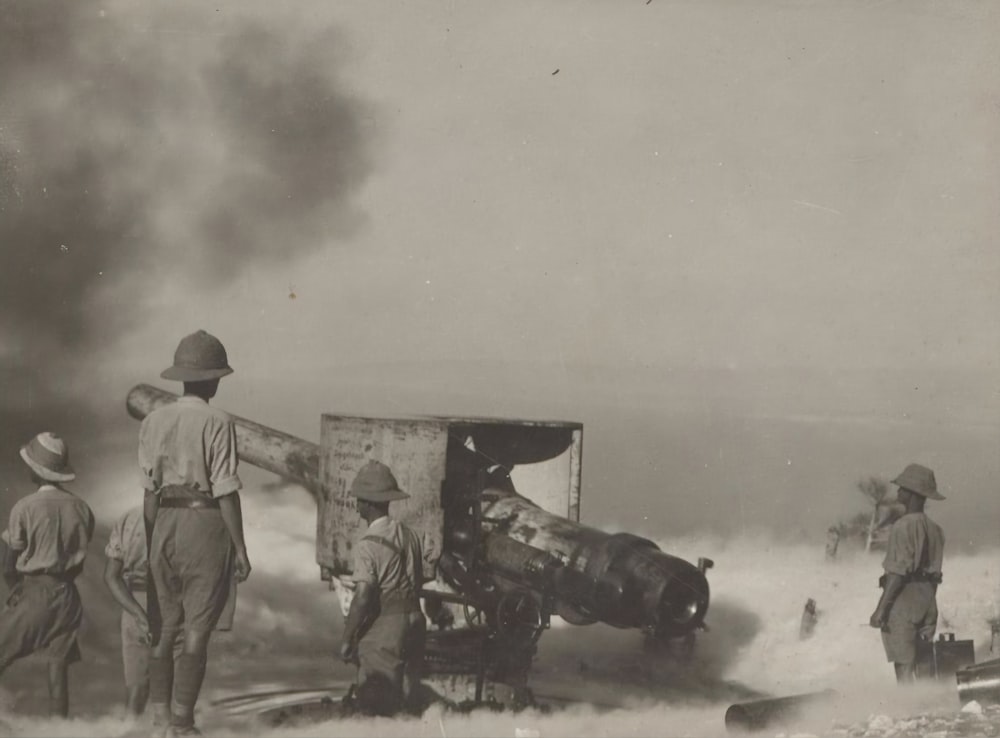 a group of men standing around a wrecked airplane