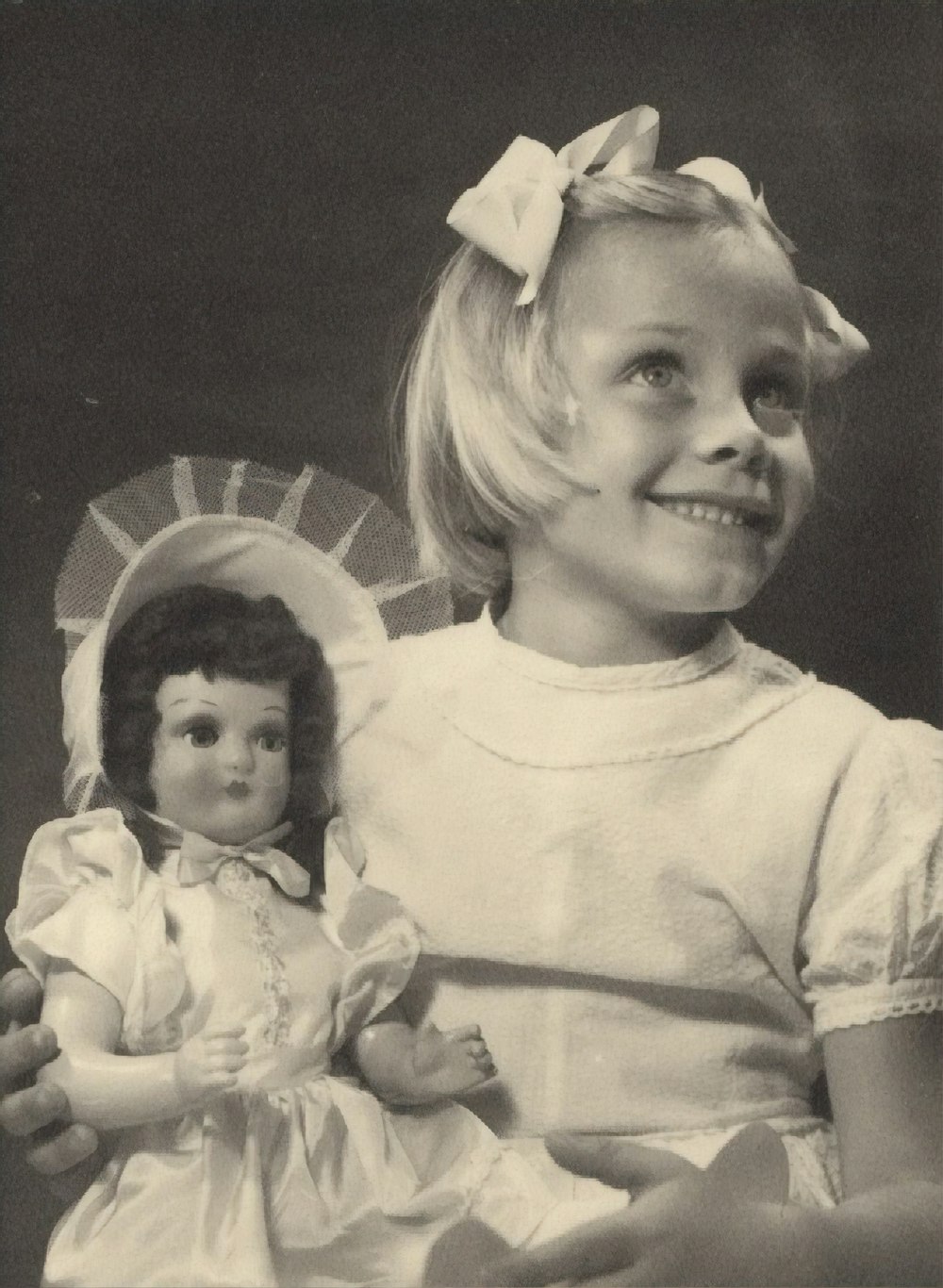 girl holding doll