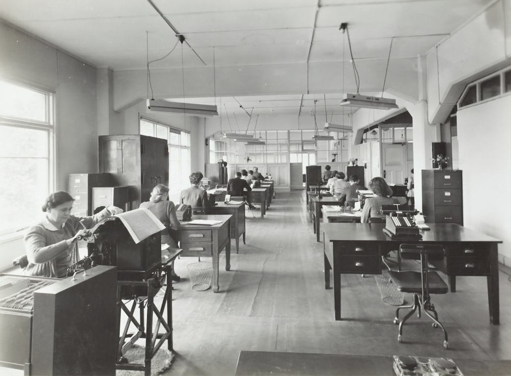 a black and white photo of people in a room