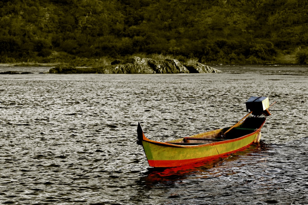 red and yellow boat on ocean