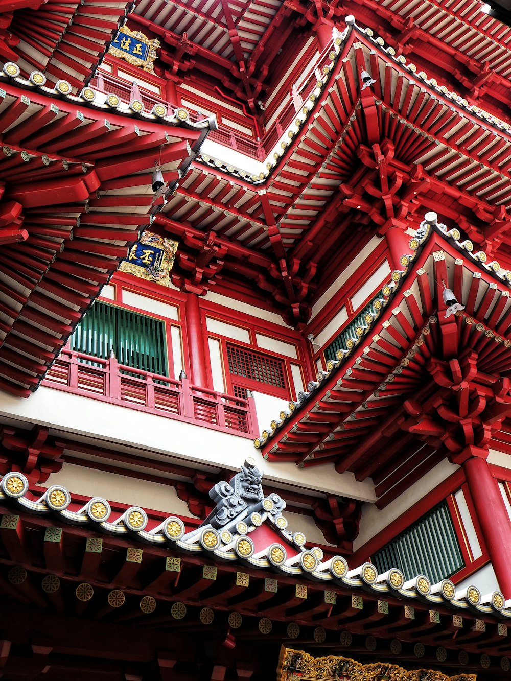 low-angle photography of red and white temple