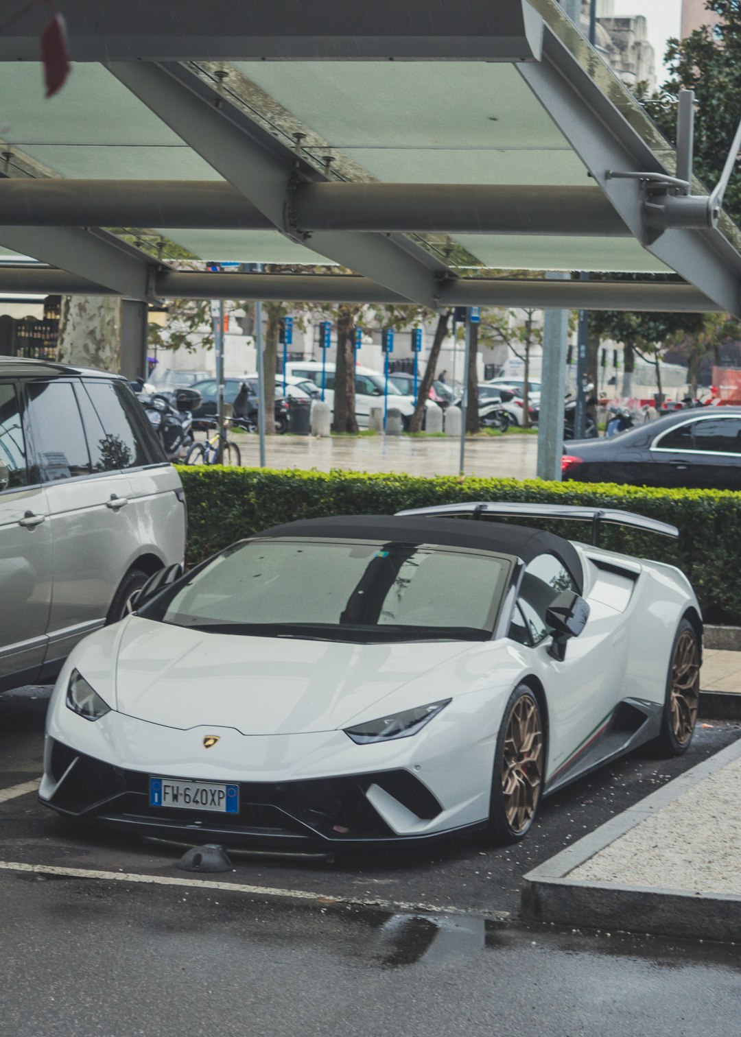 parked white Lamborghini Huracan coupe during daytime