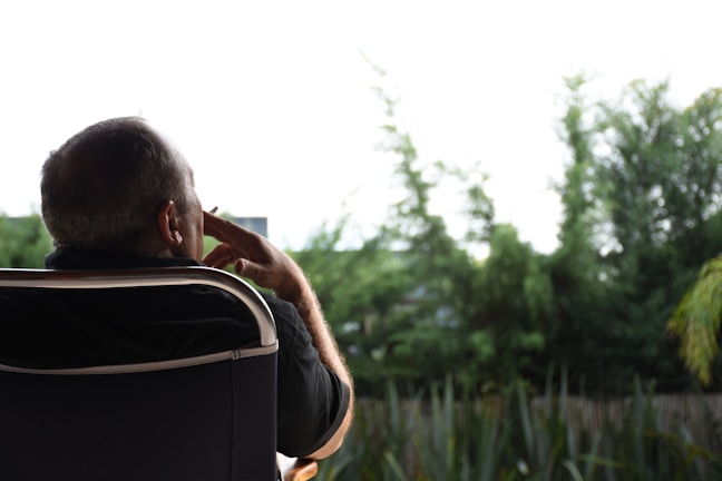 A serene outdoor setting with a writer deep in thought.