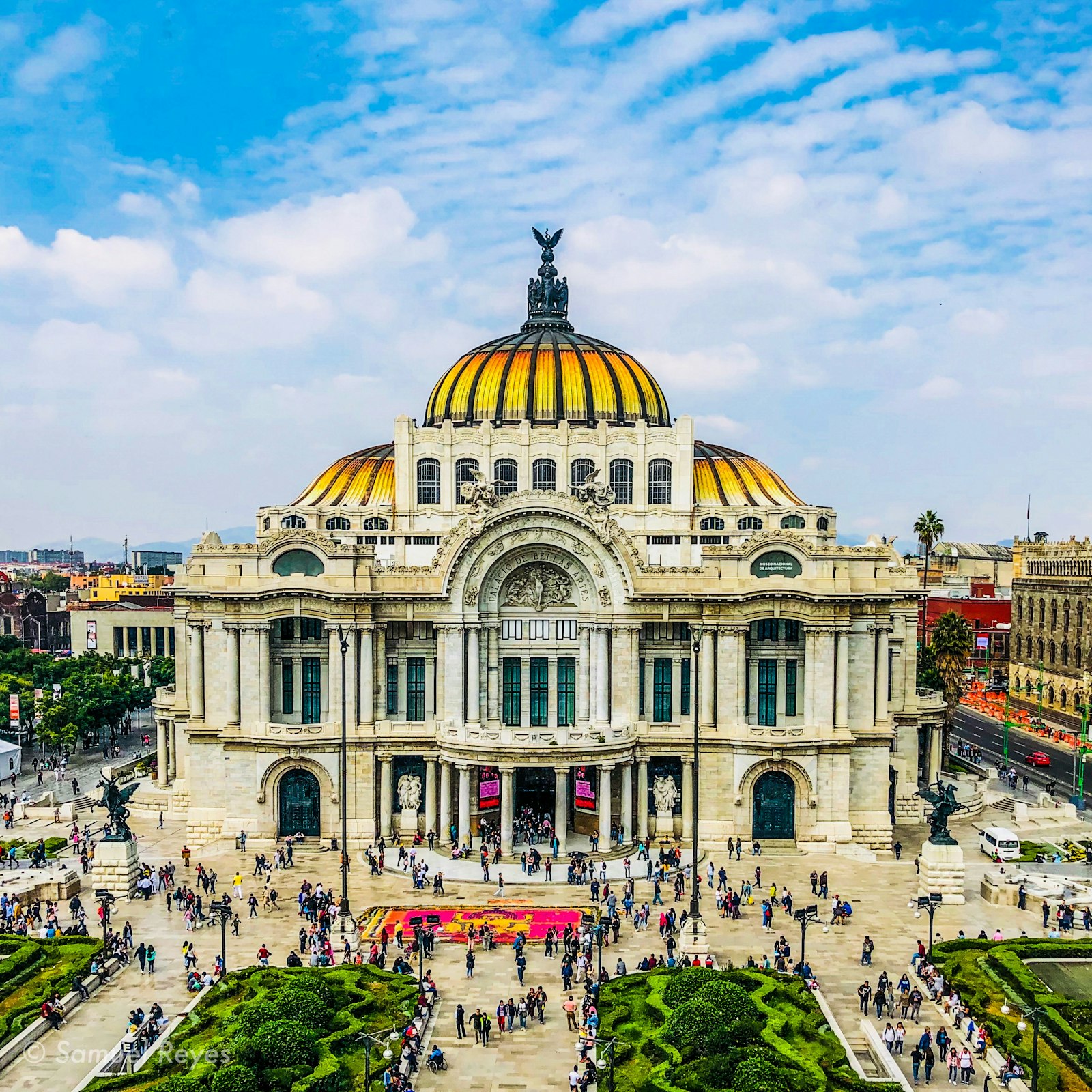 The golden dome of the Palacio de Bellas Artes against a blue sky in downtown Mexico City