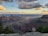 Smiling tourists admiring the vast Grand Canyon landscape during a guided tour.