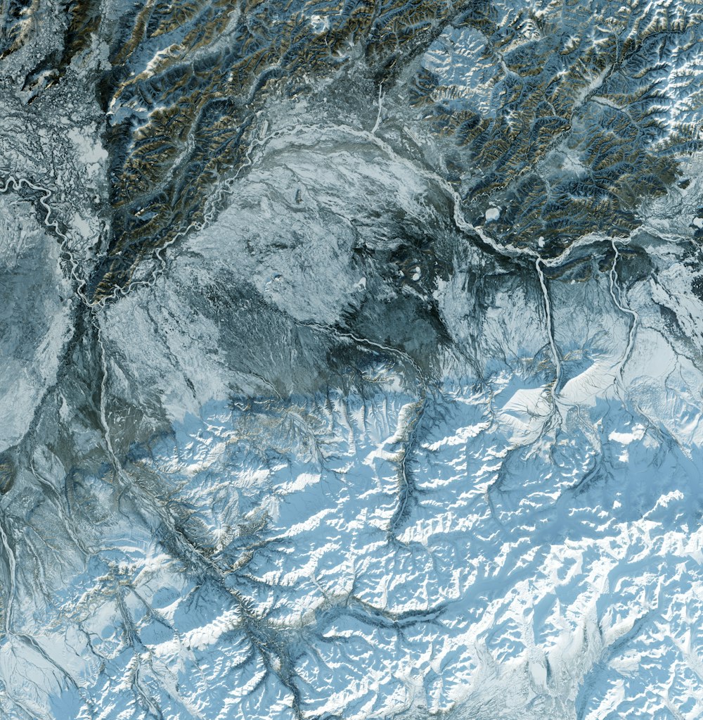 an aerial view of a snow covered mountain range