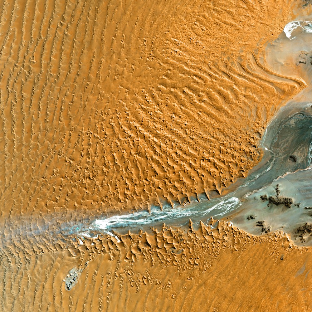 an aerial view of a river running through a desert