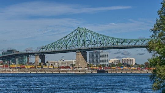 gray bridge during daytime in Jacques Cartier Bridge Canada