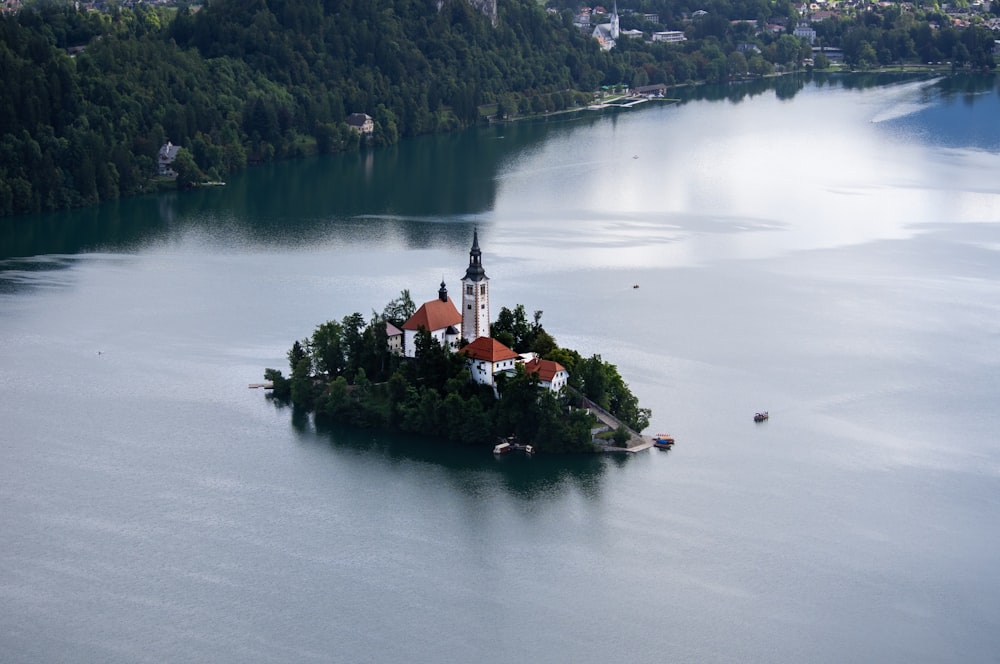 white and red houses surrounded by body of water