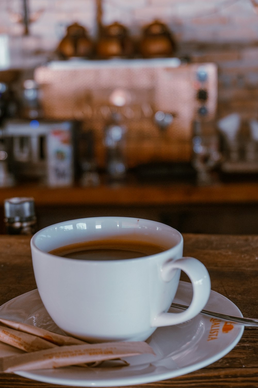 white teacup on saucer