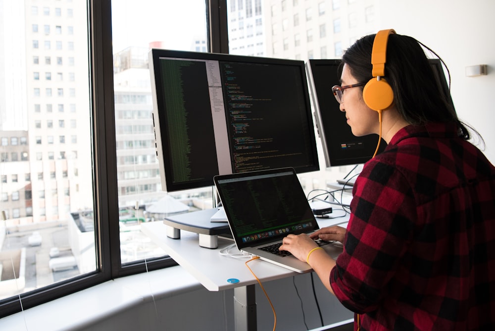 shallow focus photo of woman using laptop computer