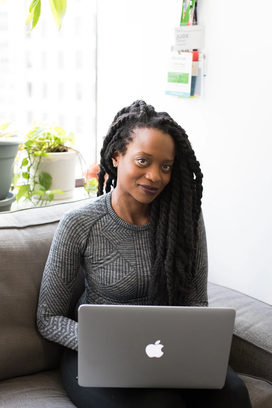 A young African educator preparing her lesson on a laptop